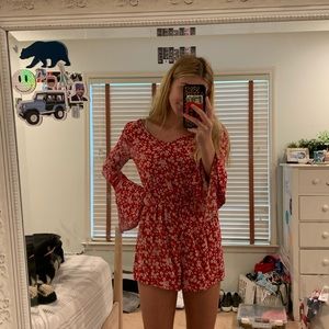 red flowy romper with white flowers